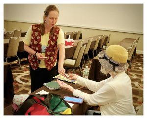 Lisa teaching with a balloon folding student - Photo by John Sutton